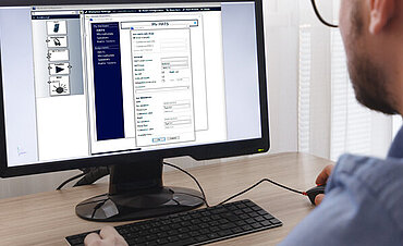 Engineer, Constructor, Designer in Glasses Working on a Personal Computer. He is Creating, Designing a New 3D Model of Aircraft, Airplane in CAD Program. Freelance Work